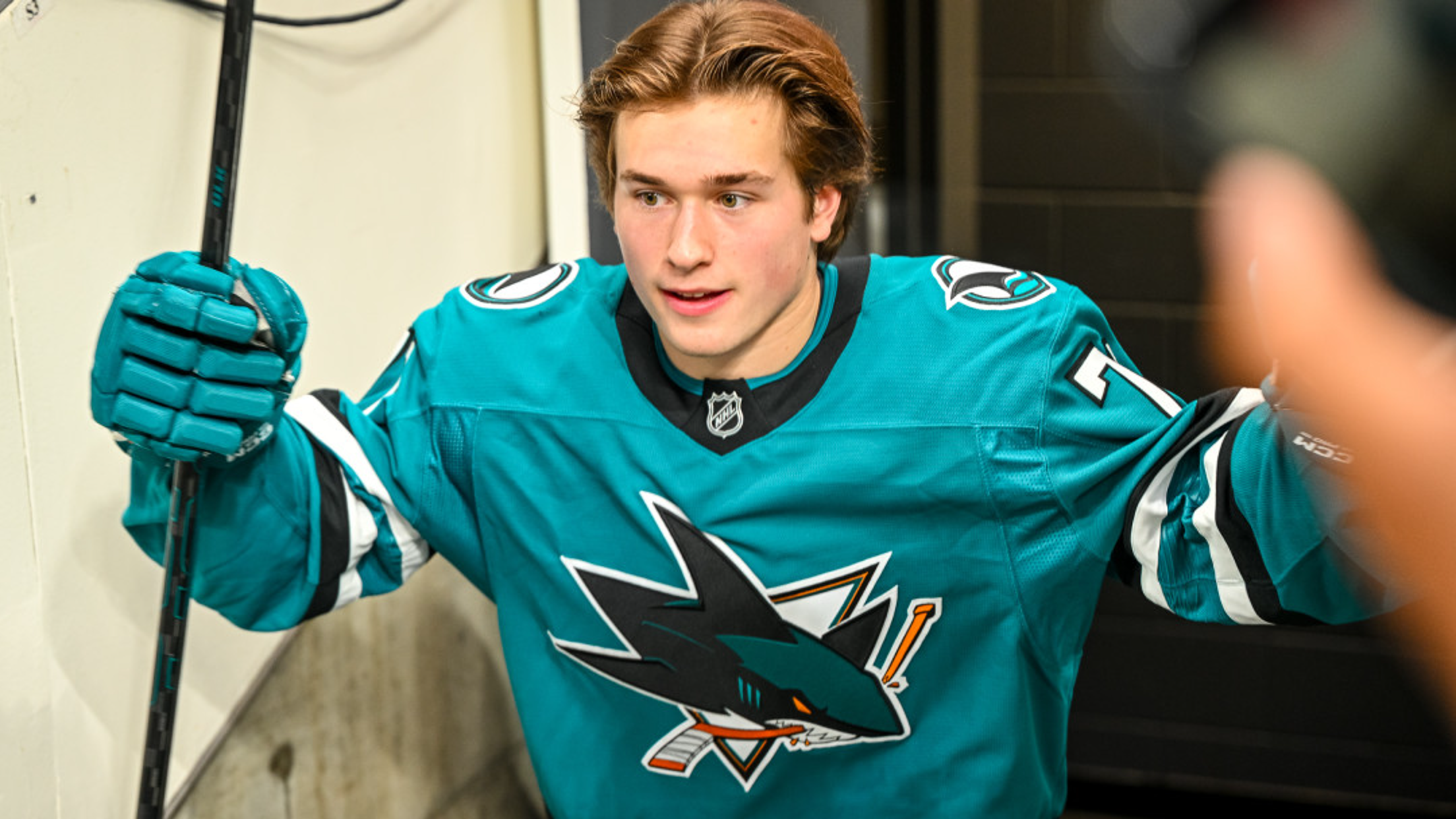 Macklin Celebrini in action on the ice, with his age being a topic of interest among fans